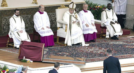 Pope Francis with a fallen icon of Christ