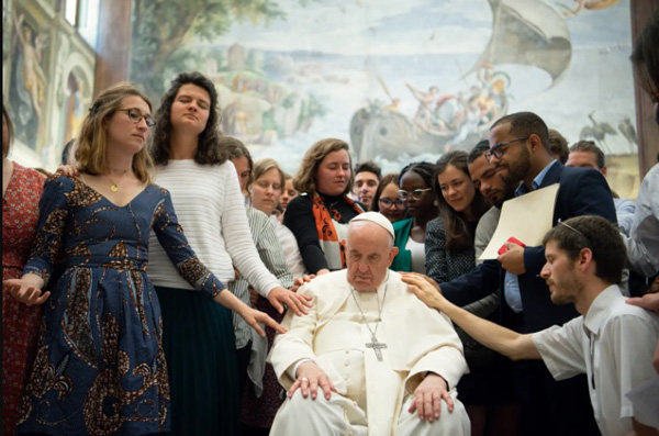 Youth lays hand on Francis